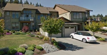 Modern suburban houses with a white car parked outside.