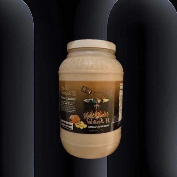 A jar of Cajun seasoning labeled "I want it" with a black background.