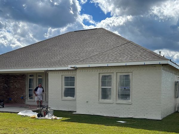 Painting a brick home. 