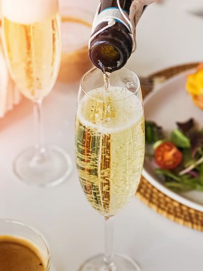 Champagne being poured into a flute glass.