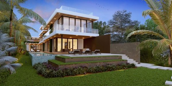 Modern luxury house with large glass windows and a pool in a tropical garden.