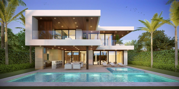 Modern two-story house with a pool and palm trees at sunset.