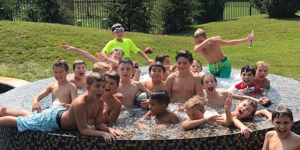 A group of children enjoy swimming full