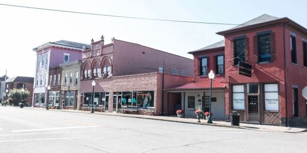 Small town street with historic buildings under clear sky.