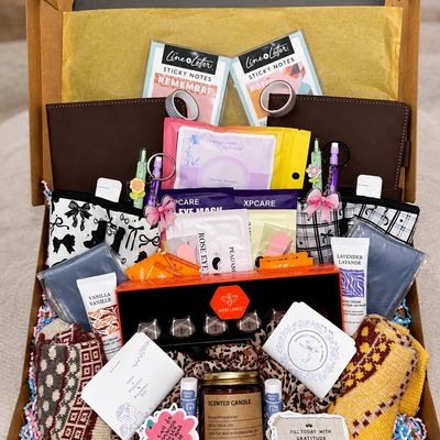Gift basket filled with self-care items and stationery.
