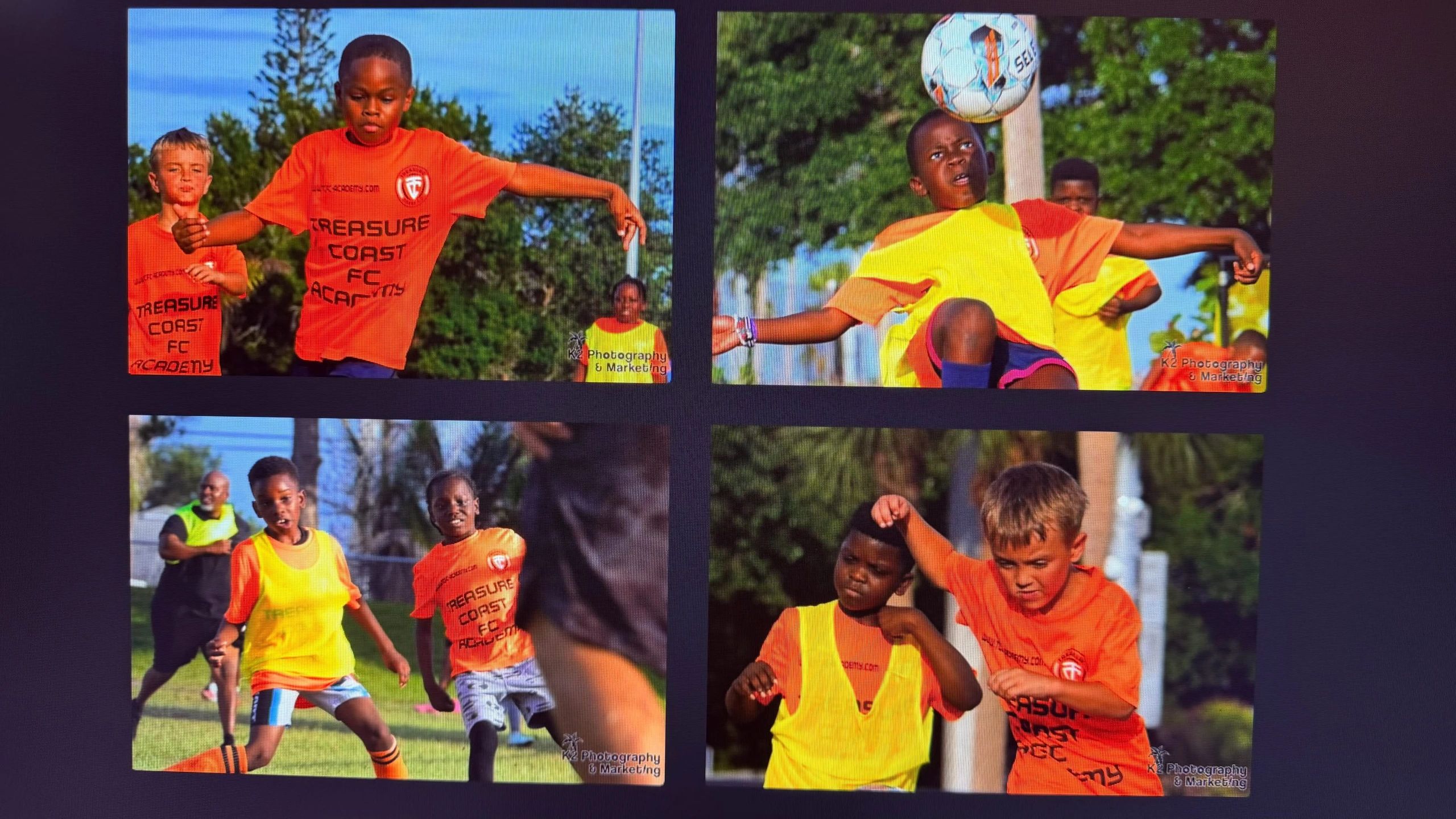Young kids playing soccer wearing orange and yellow jerseys at Treasure Coast FC Academy.