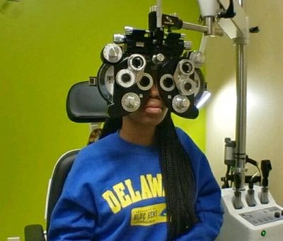 Dr. Stella Ohanenye, our eye doctor performing Eye exam in our Middletown, Delaware office