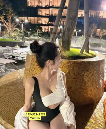 Woman in a swimsuit sitting outdoors at night.