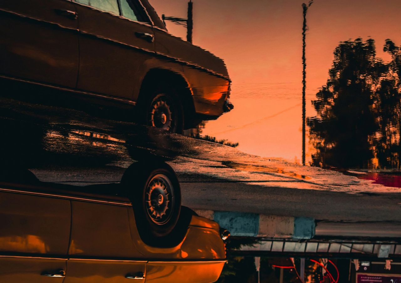 A car mirrored on a puddle