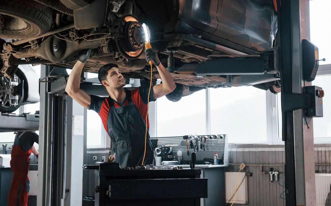 A person repairing a car