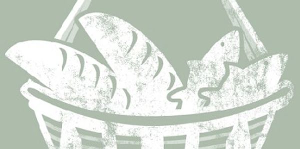 Basket of bread and leaves illustration.