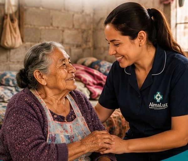 Young caregiver smiling warmly while holding elderly woman's hands.
