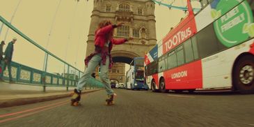 Person rollerblading near Tower Bridge in London.