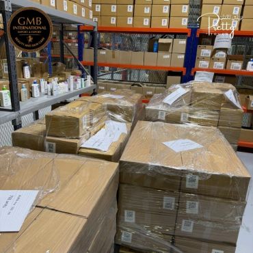 Warehouse with stacked and wrapped cardboard boxes ready for shipment.