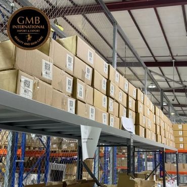 Warehouse shelves stocked with numerous cardboard boxes labeled for export.