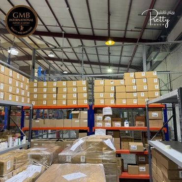 Warehouse shelves stocked with neatly organized boxes and packages.