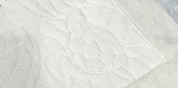 White textured towel with a subtle sea turtle design.