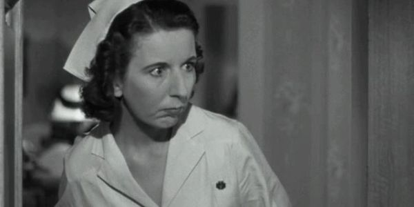 Black and white photo of a concerned nurse.
