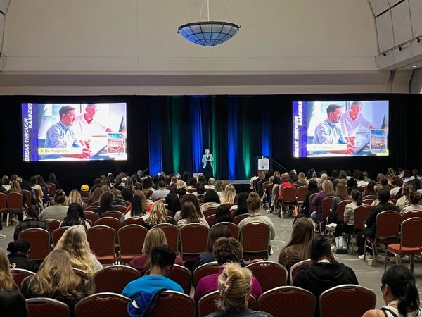 Sabrina Wilson presents to a large audience at Women in Manufacturing Summit in Boston.