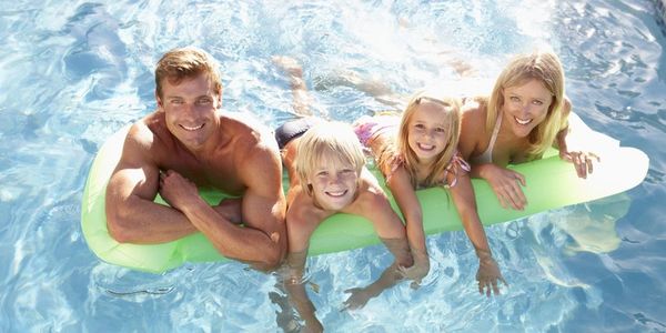 Family in nice clean pool.