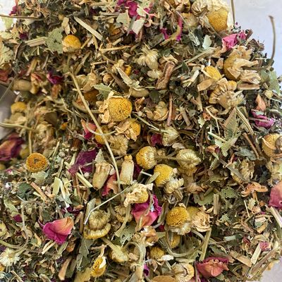 Close up of dry herbal tea with mix of colourful flowers and leaves