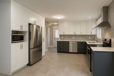 white cabinet kitchen with grey floors and grey tile