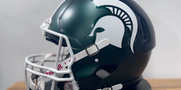 Green football helmet with a white Spartan logo on the side.