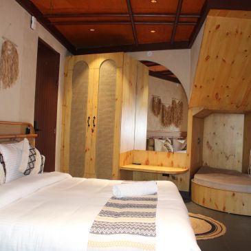 Cozy rustic bedroom with wooden furniture and warm lighting.