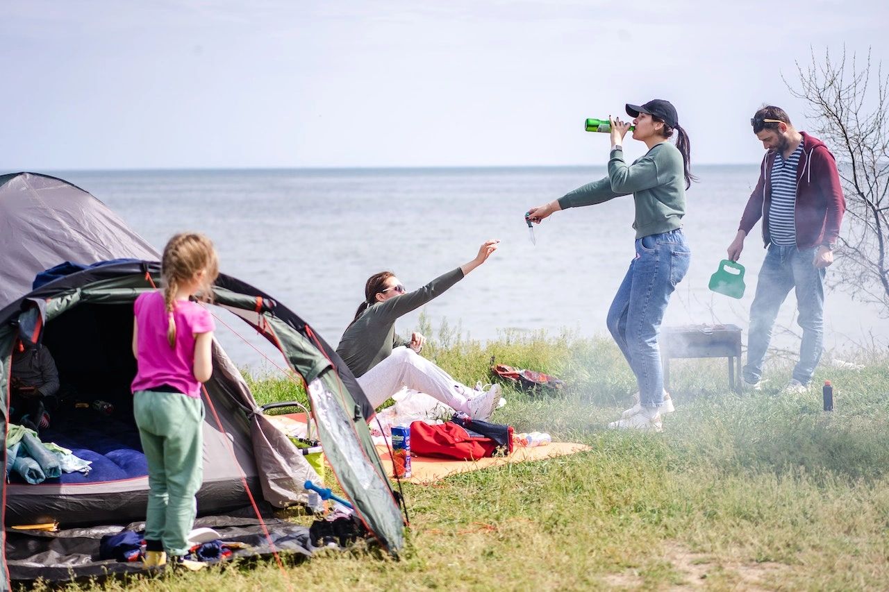 Family outside of their Tent on a Camping Vacation.