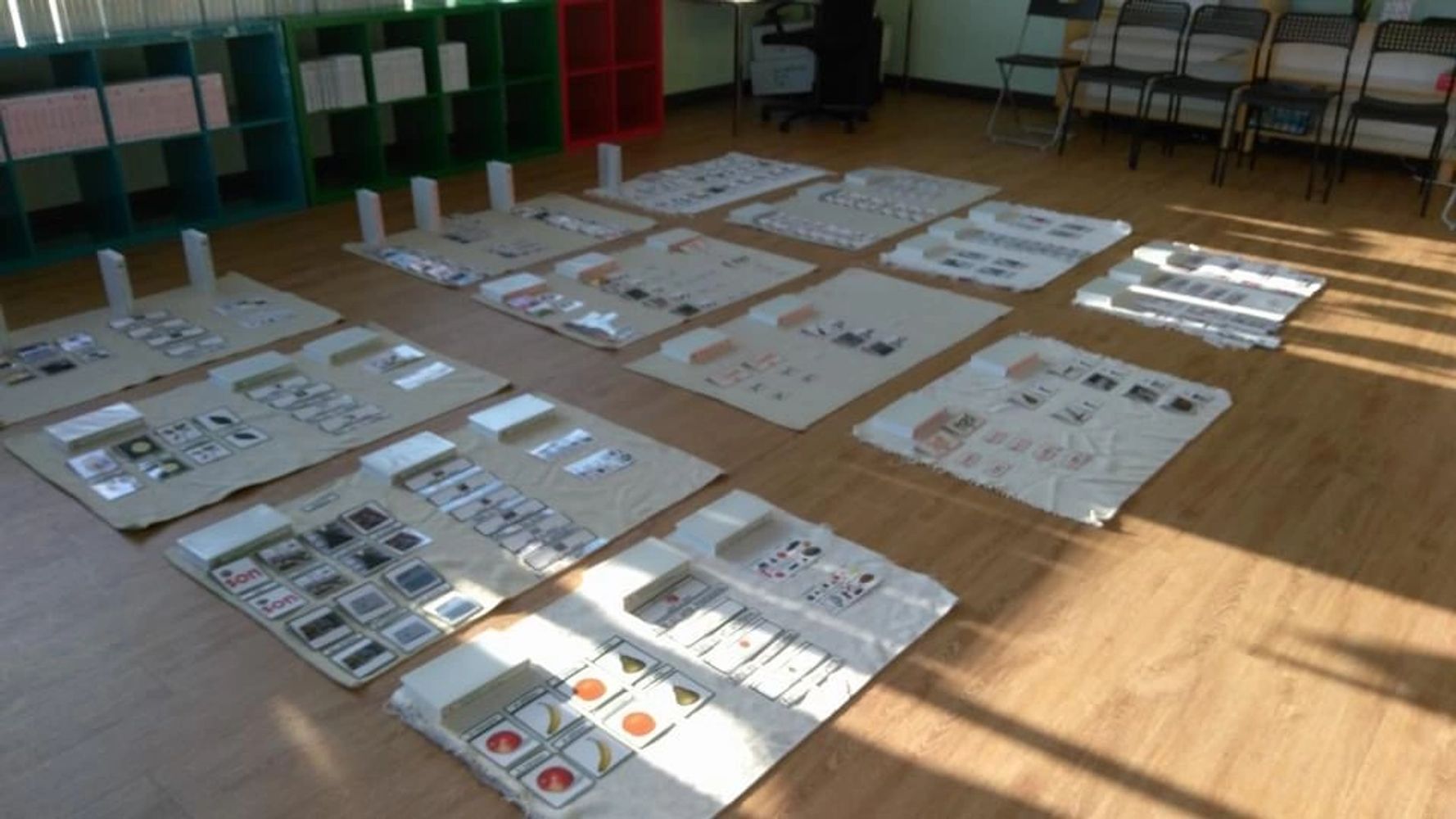 Educational cards and materials organized on the floor in a classroom setting.