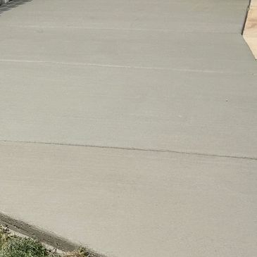 Wide concrete sidewalk outdoors.