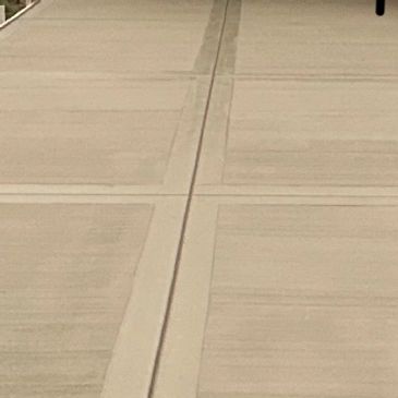 Empty concrete sidewalk with expansion joints.