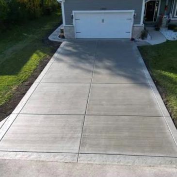 Newly paved driveway leading to a two-car garage.