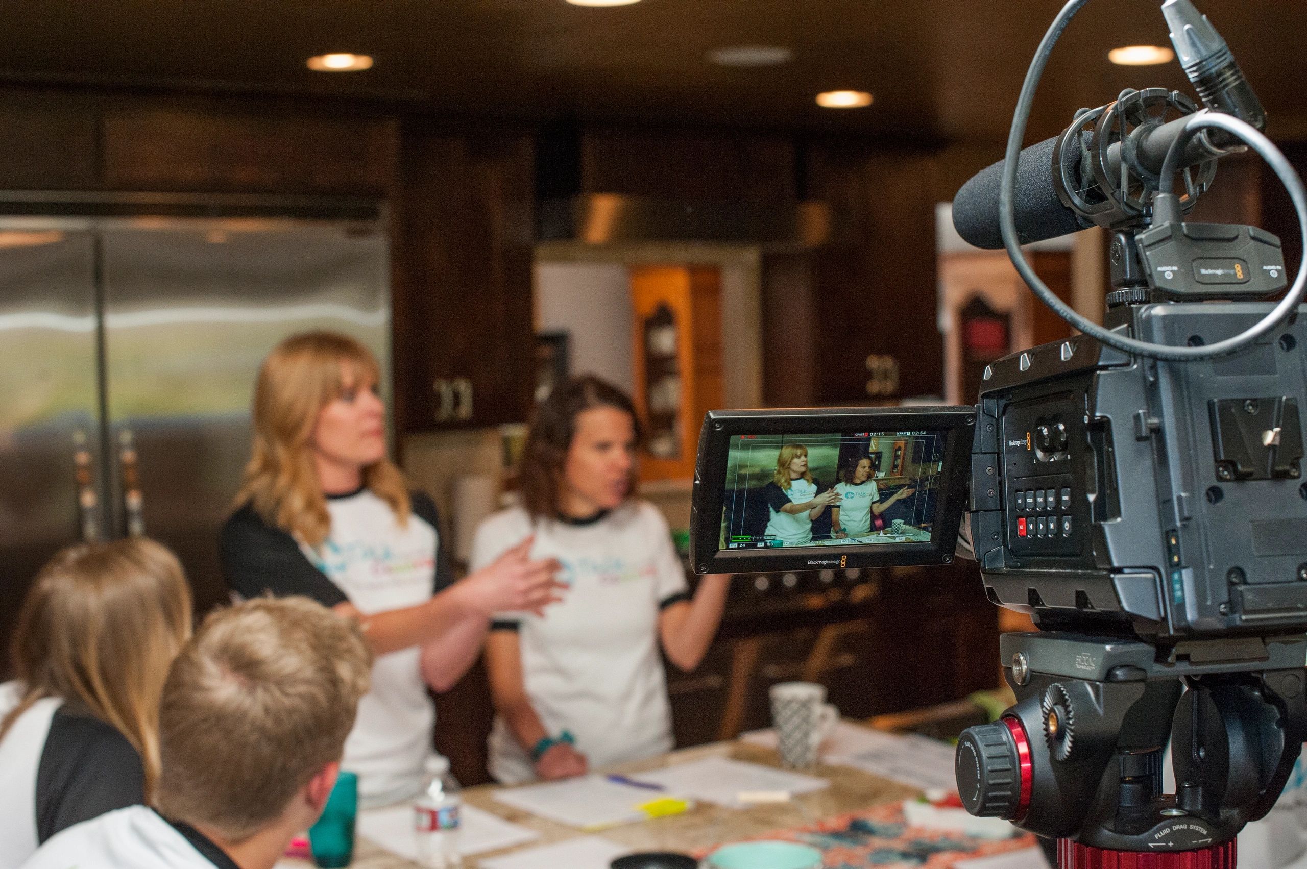 Co-Founders, Audrey Walters and Jenny Gilbert, talking to instructors, while being filmed.