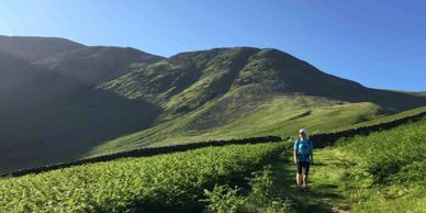 Lady navigating in the hills on a hill skills course with map and compass