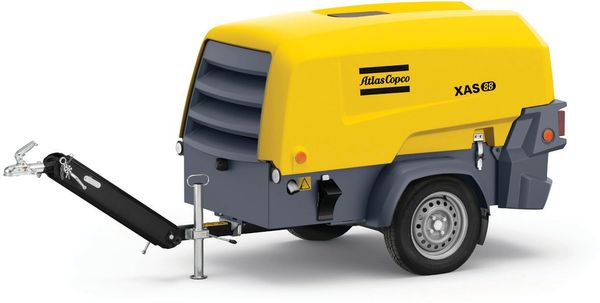 Yellow and gray mobile air compressor with a tow hitch.