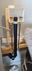 Modern black and beige floor lamp with a basket and hanging light.