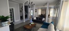 Spacious living room with modern furniture and neutral tones.