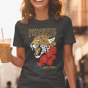 Woman wearing a black "Fearless" t-shirt with a roaring leopard and red flowers design.