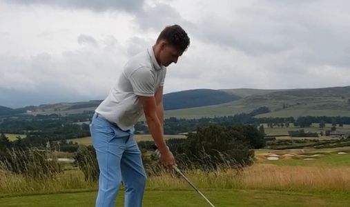 Golf lessons on a golf course in Manchester. Golf Professional taking a golf shot 