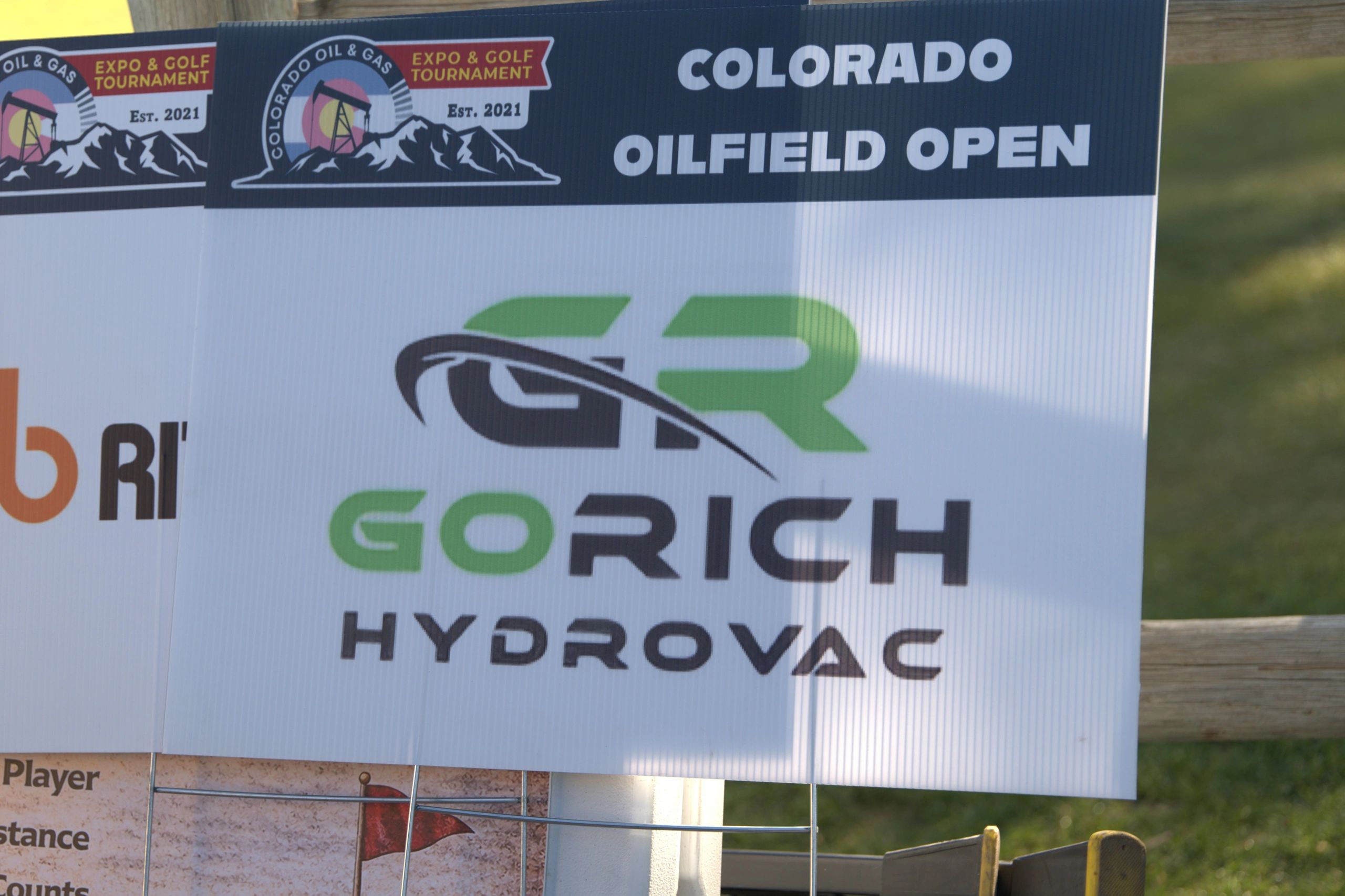 Sign for the Colorado Oilfield Open golf tournament featuring GoRich Hydrovac.