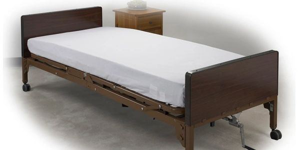 Hospital bed with fitted sheet