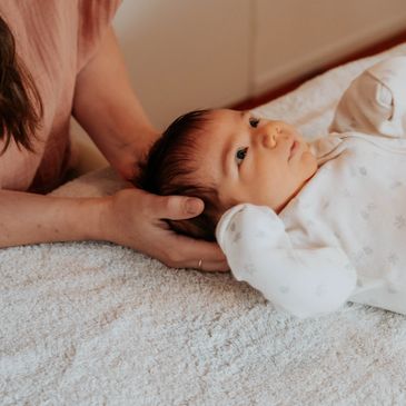 Treating a baby. Joanna is an Osteopath in croydon who treats newborns and infants