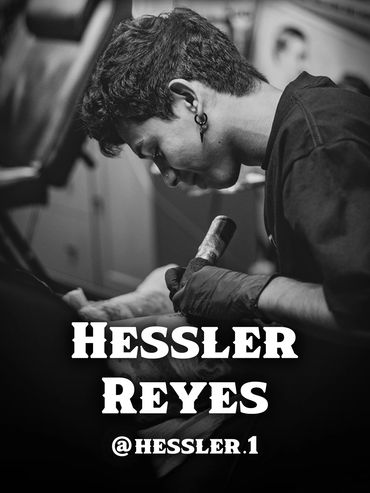 Black and white photo of a tattoo artist focused on inking a client.