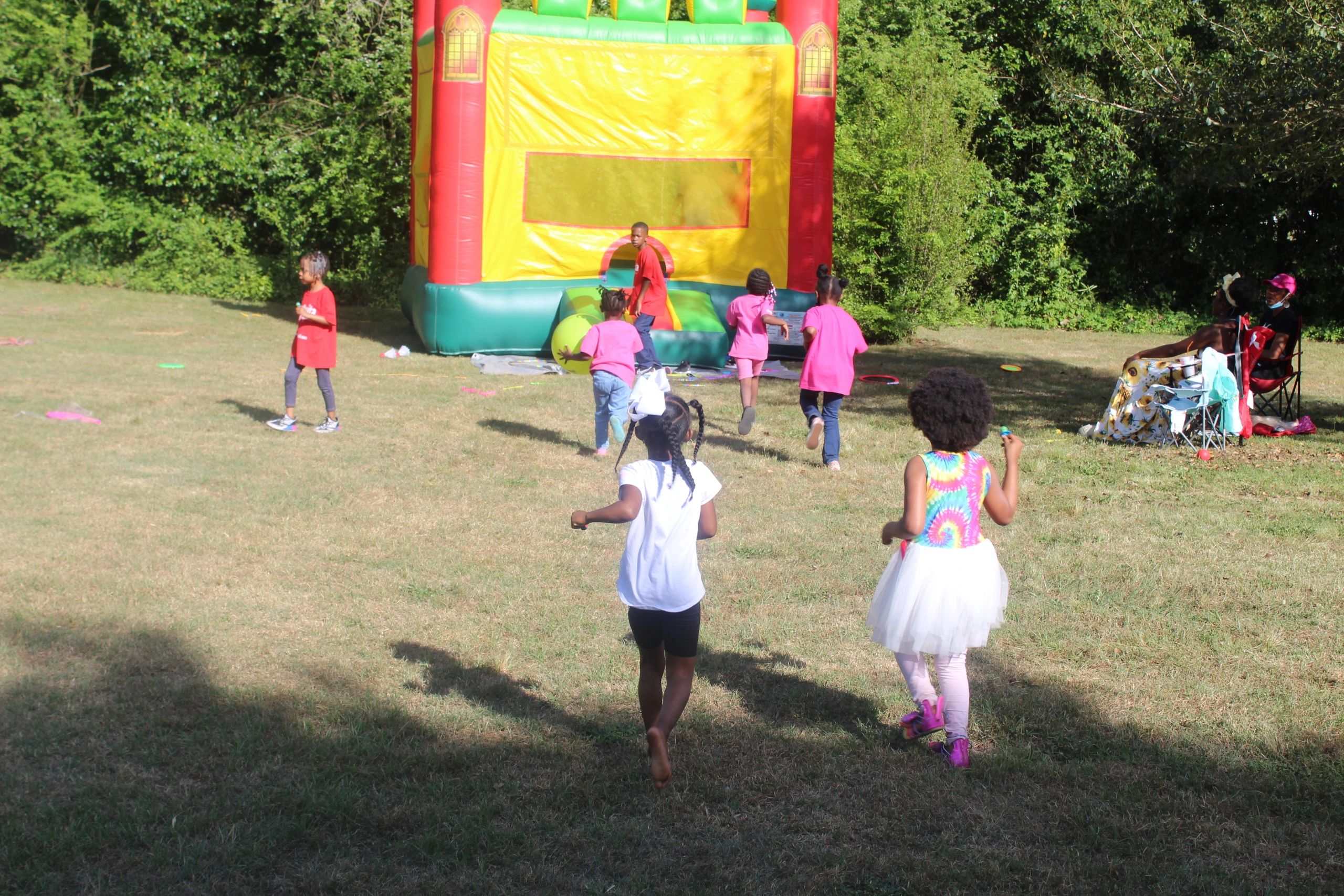 The children were running to enjoy the bounce castle.