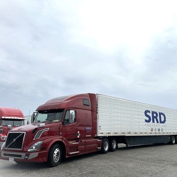 Red SRD Freight Inc. semi-truck with a white 53' long dry van trailer.