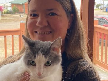 A woman holding a cat