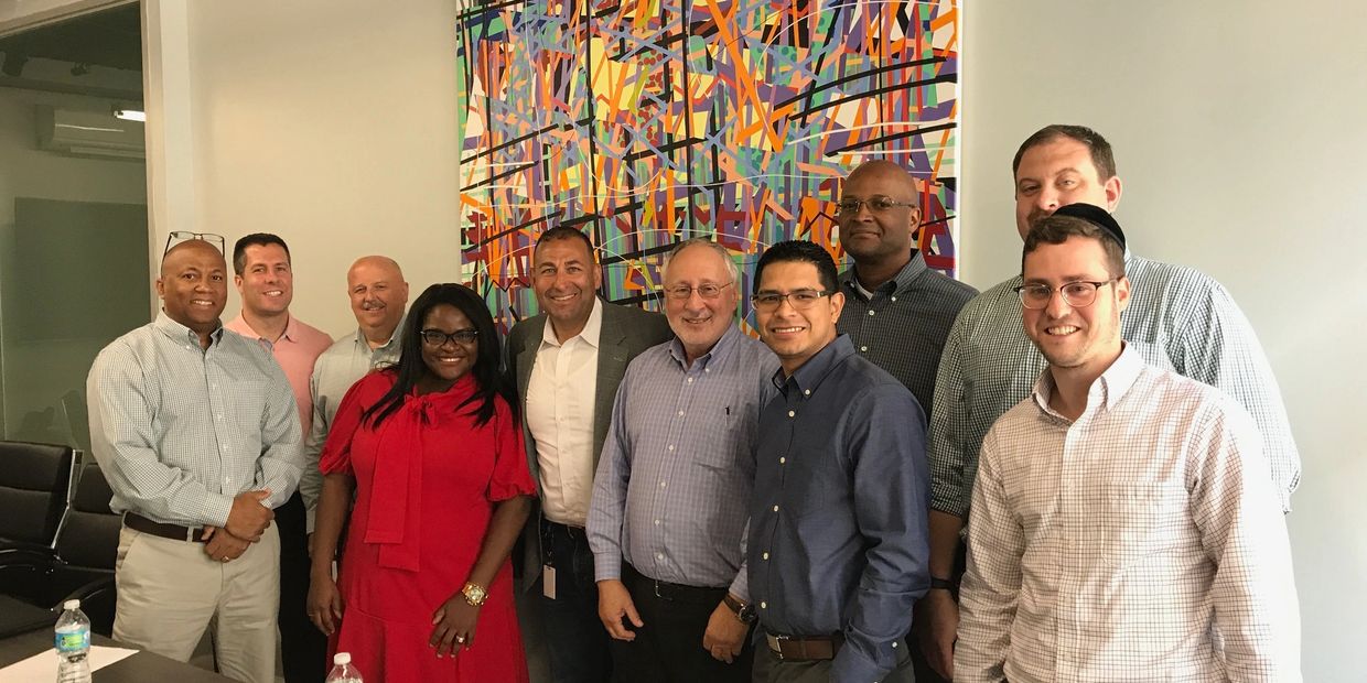 John Kaloukian with a group of clients - management is about people.