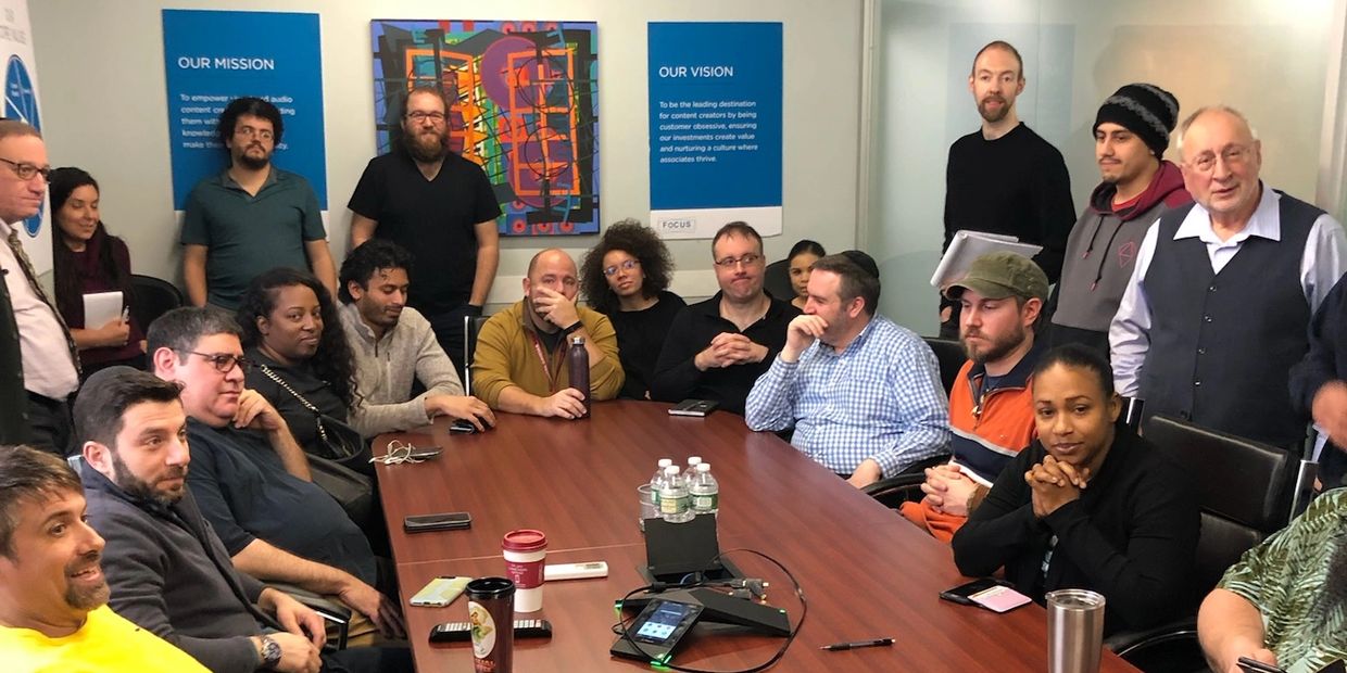 Team meeting around a table - hiring the right people is key to success.