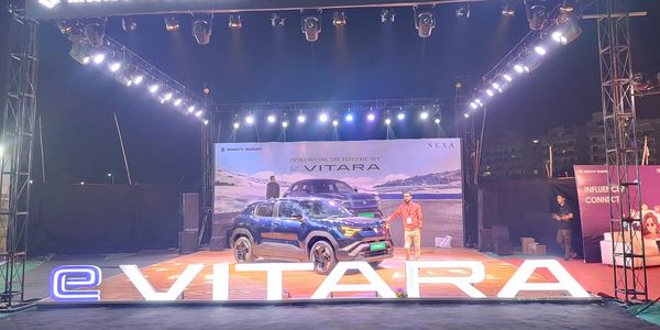 Maruti Suzuki showcases the electric SUV eVITARA at a brightly lit nighttime event.